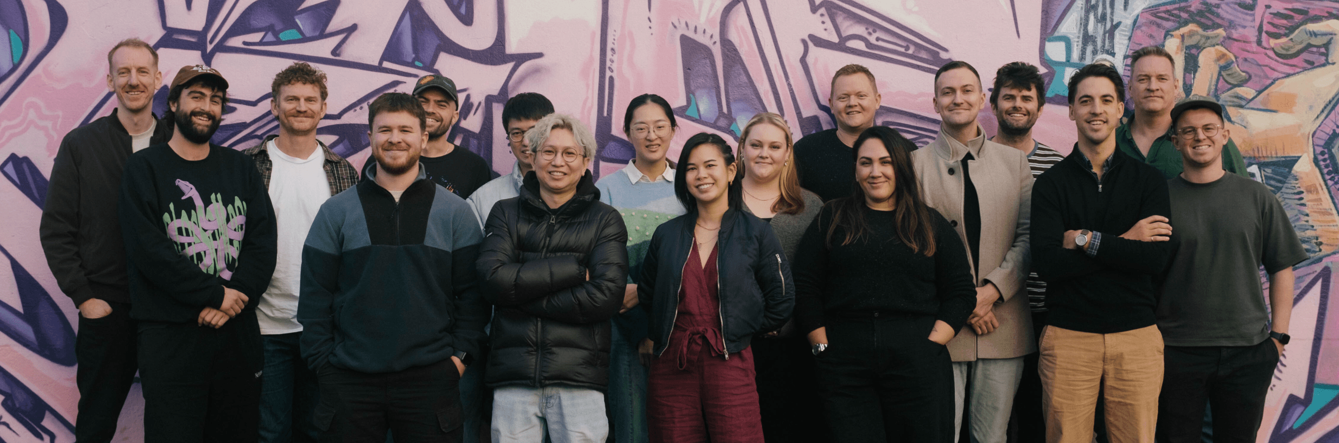 The wonderful team that make up Cuttable, taken outside the South Yarra office, against a wall of graffiti.